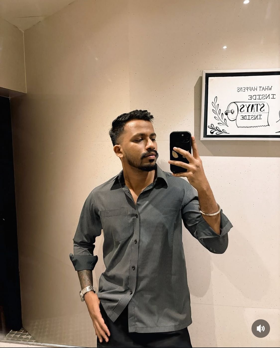 Mirror selfie of Ninad in a pinstripe shirt