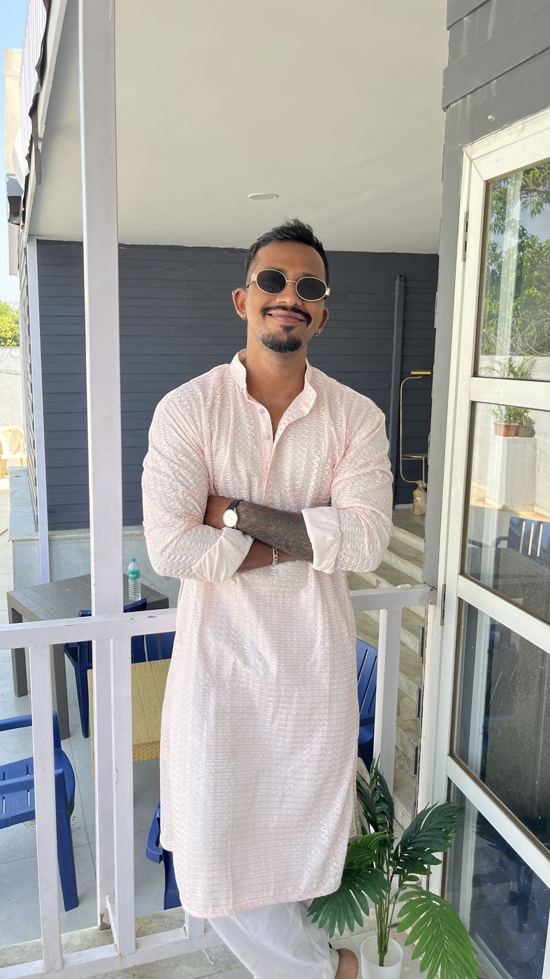 Ninad in a pink chikankari kurta and round sunglasses